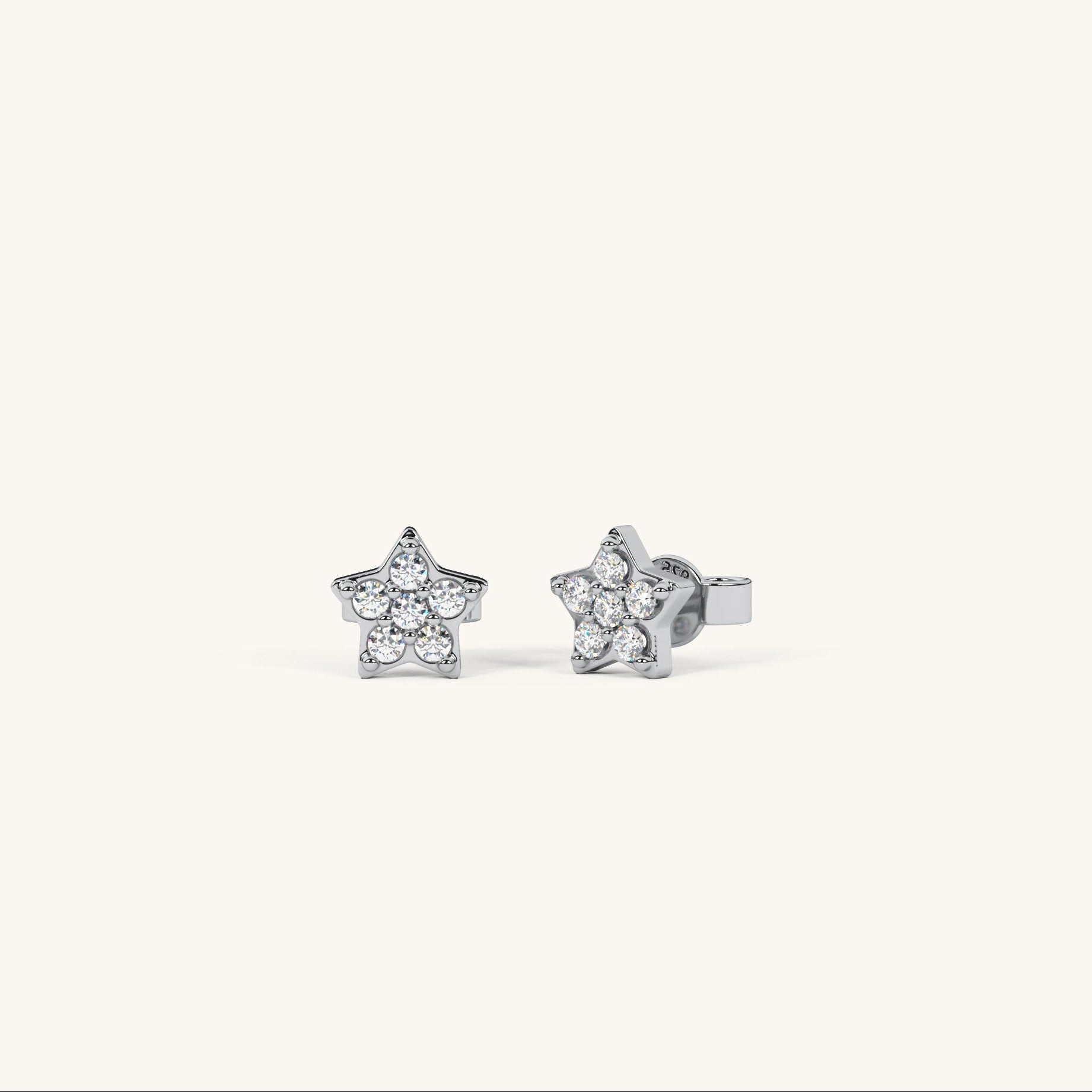 Star-shaped silver earrings with clear stones on a white background