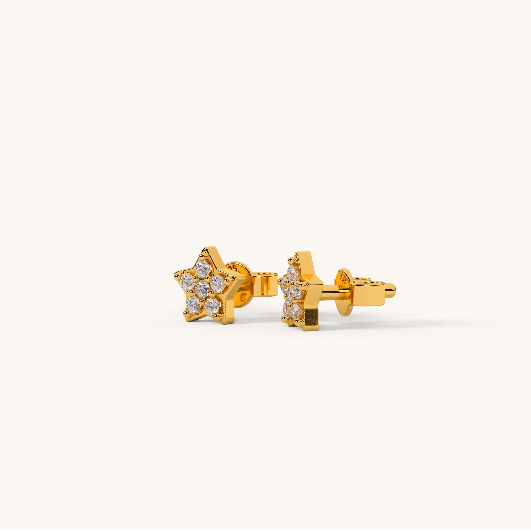 Gold star-shaped earrings with clear stones on a white background