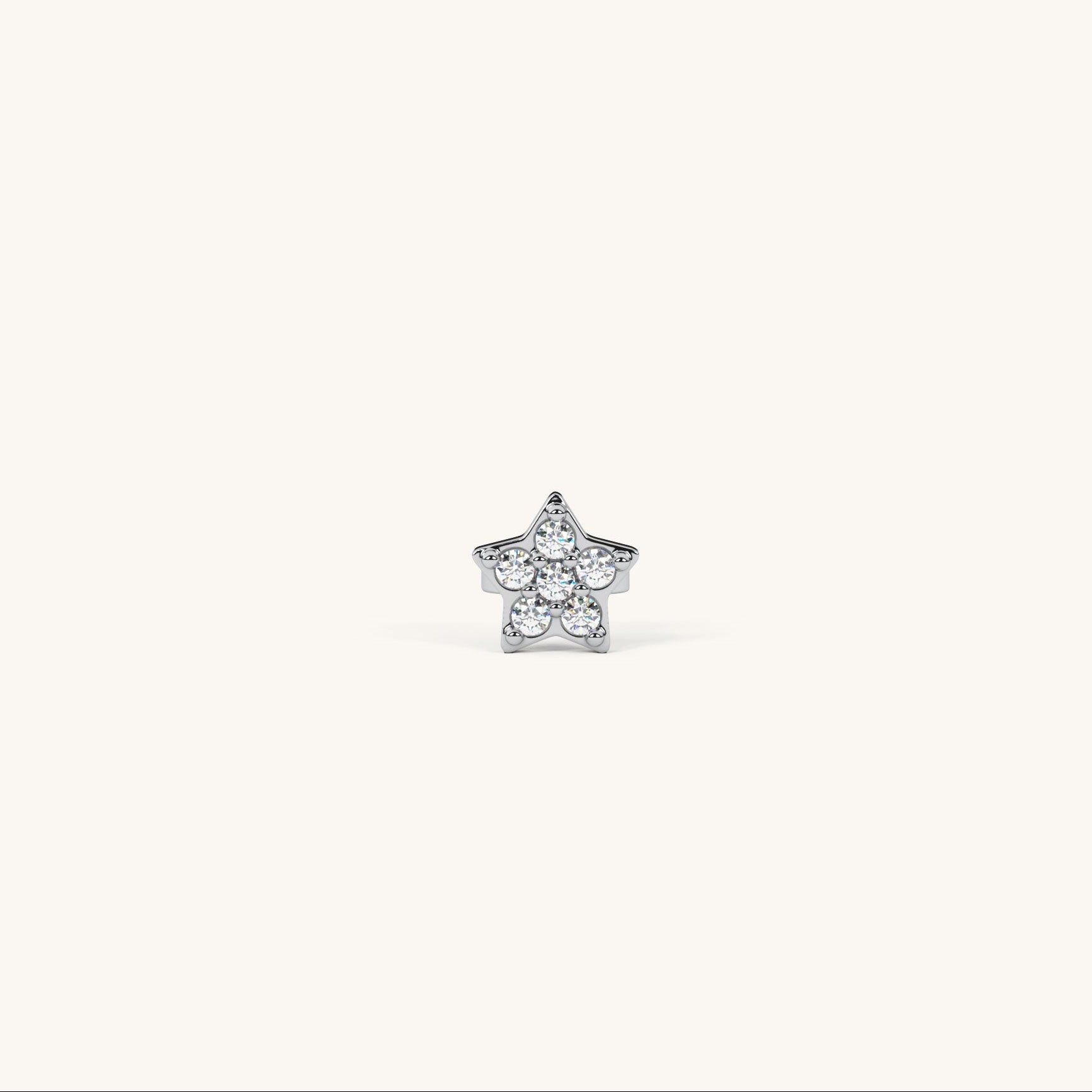Star-shaped silver earring with clear stones on a white background