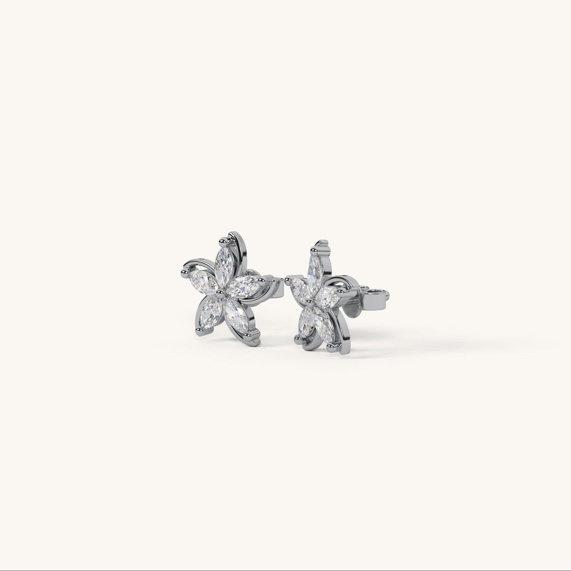Butterfly-shaped earrings with clear stones on a white background