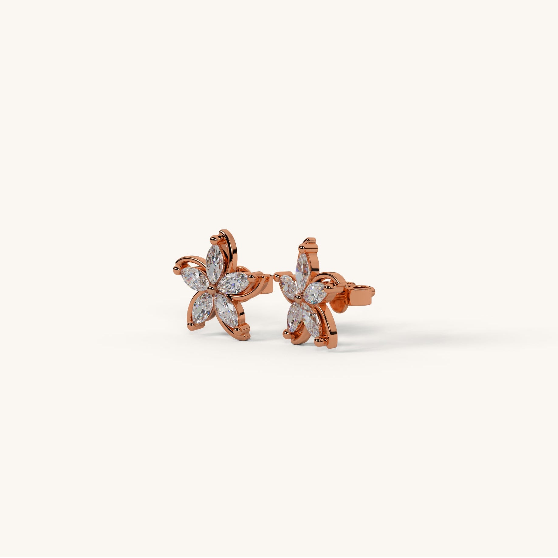 Rose gold starfish-shaped earrings with clear gemstones on a white background