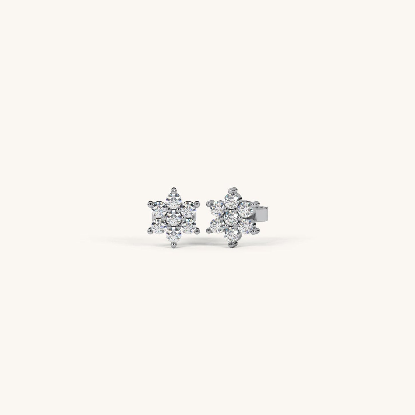 Pair of diamond stud earrings on a light gray background