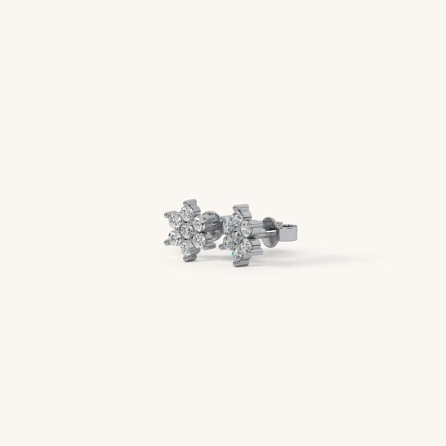 Pair of silver flower-shaped earrings on a white background