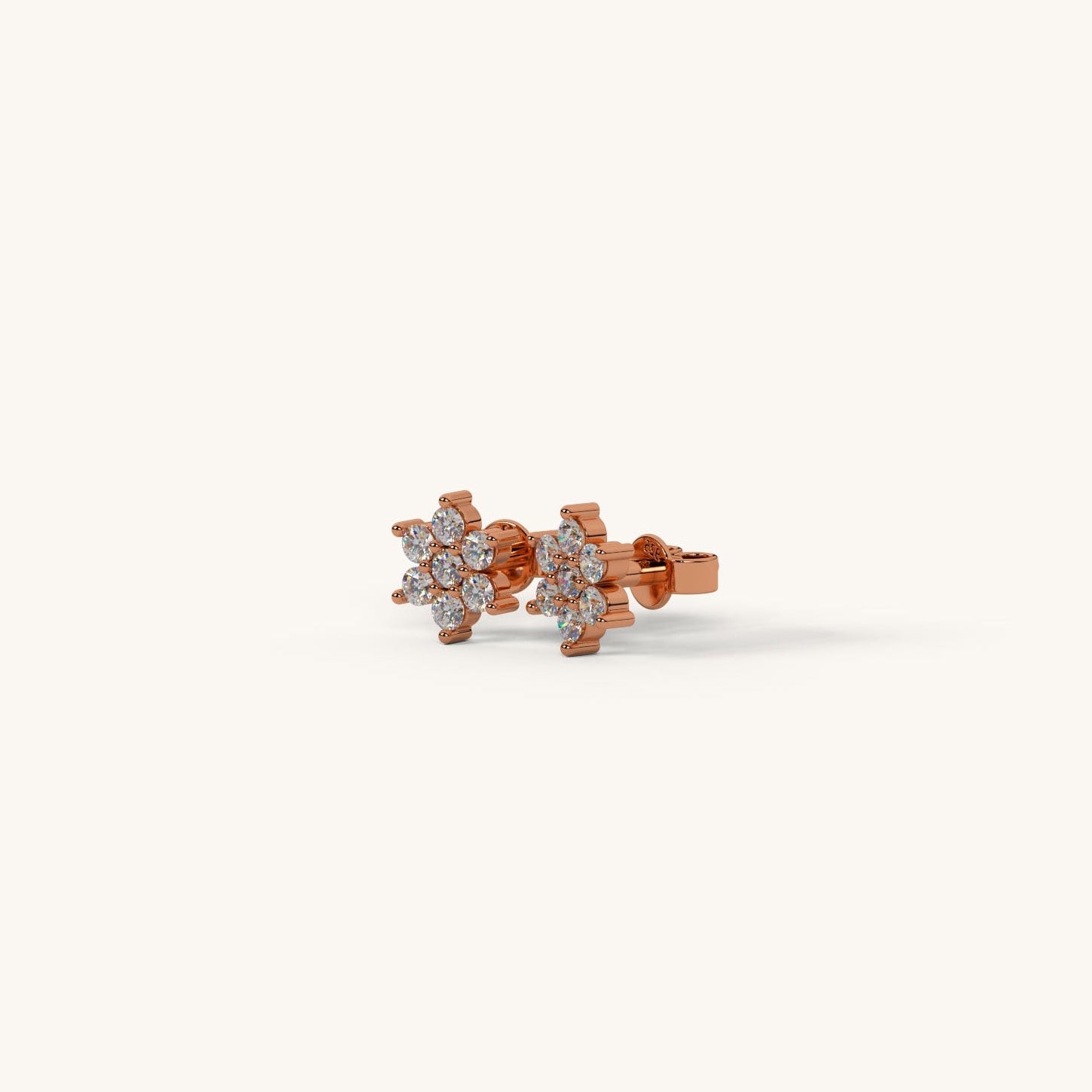 Rose gold earrings with floral design on a white background