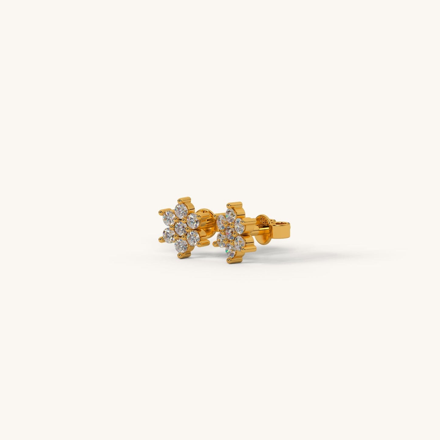 Gold earrings with floral design on a white background
