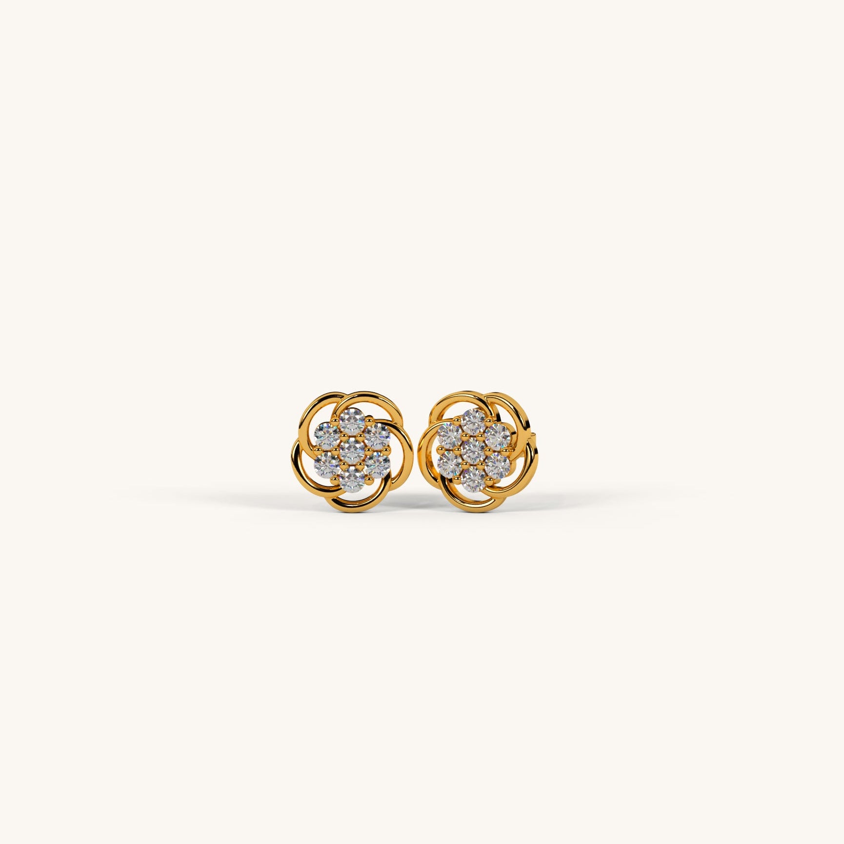 Gold earrings with diamond accents on a white background