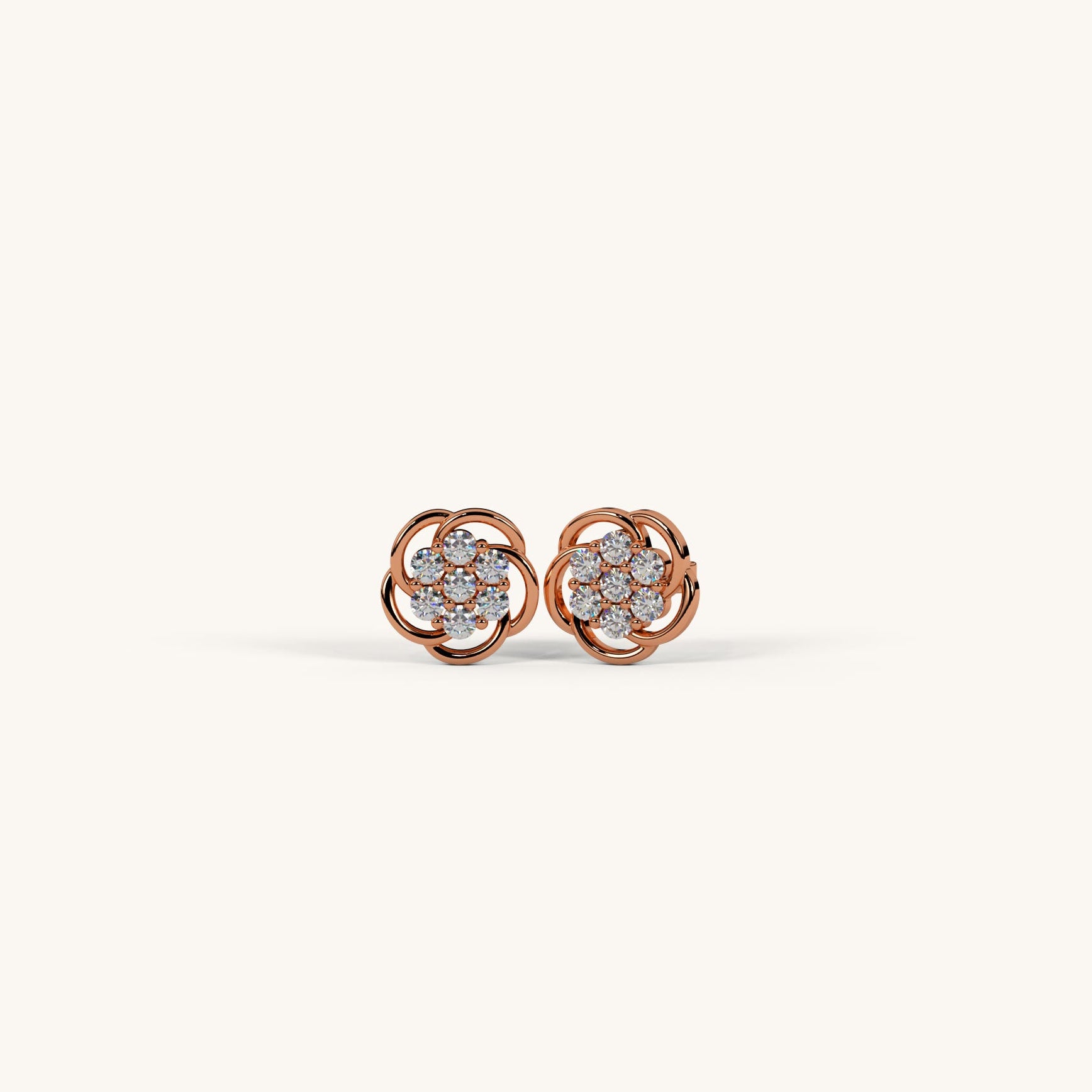 Rose gold earrings with diamond accents on a white background