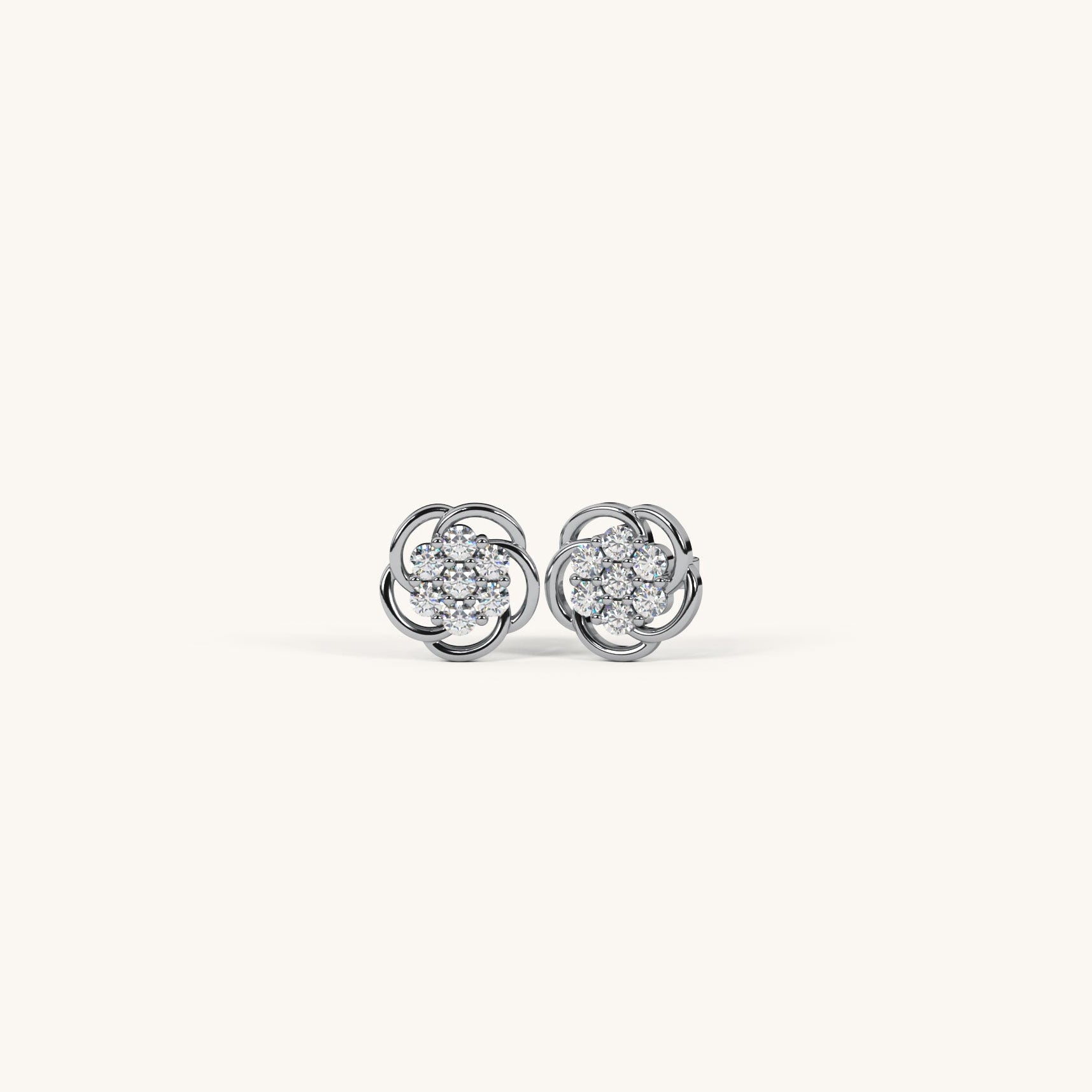 Pair of silver earrings with clear gemstones on a white background
