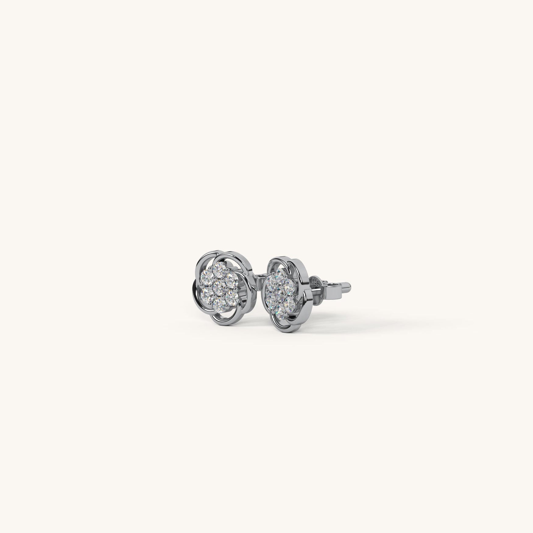 Pair of silver earrings with clear gemstones on a white background