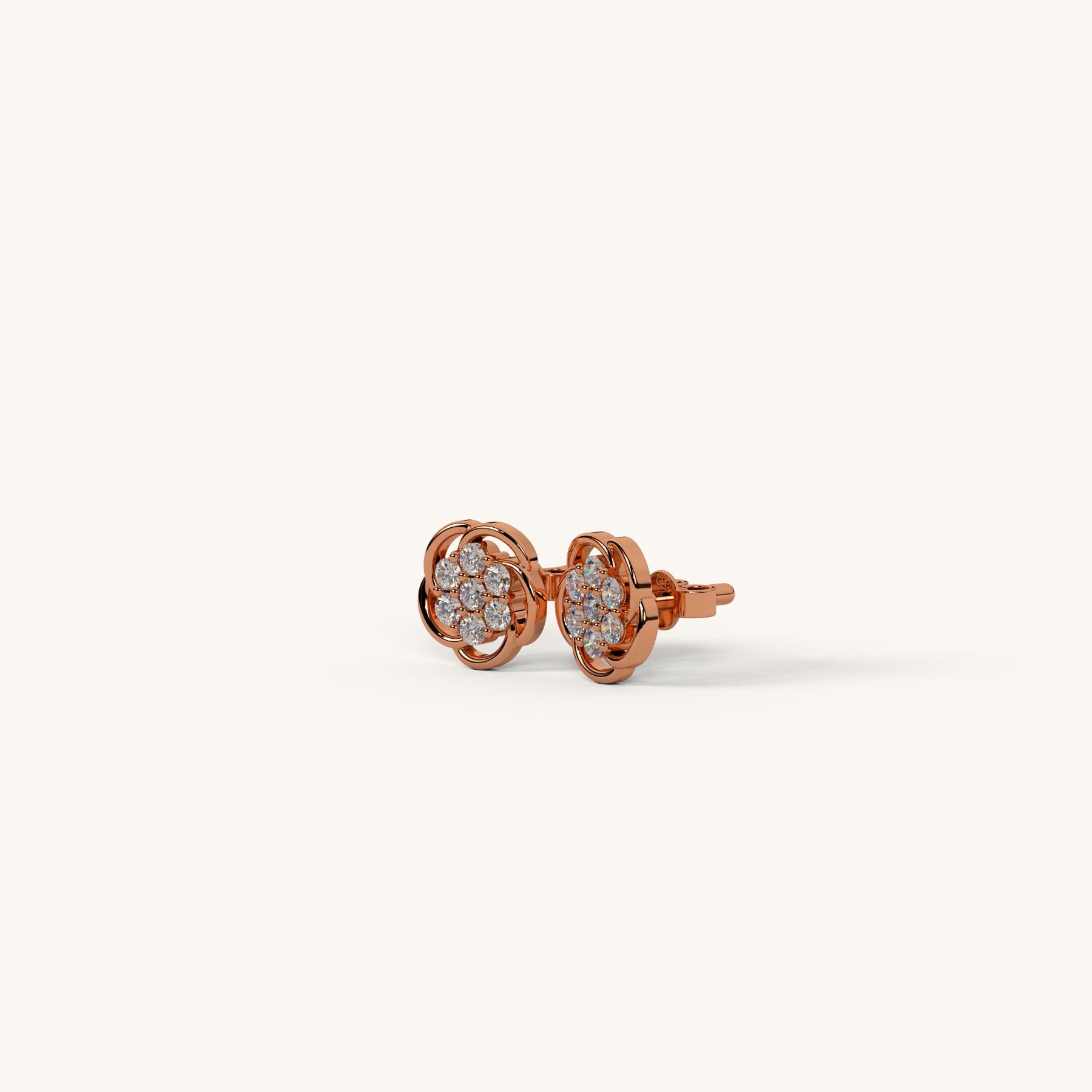 Rose gold earrings with clear gemstones on a white background