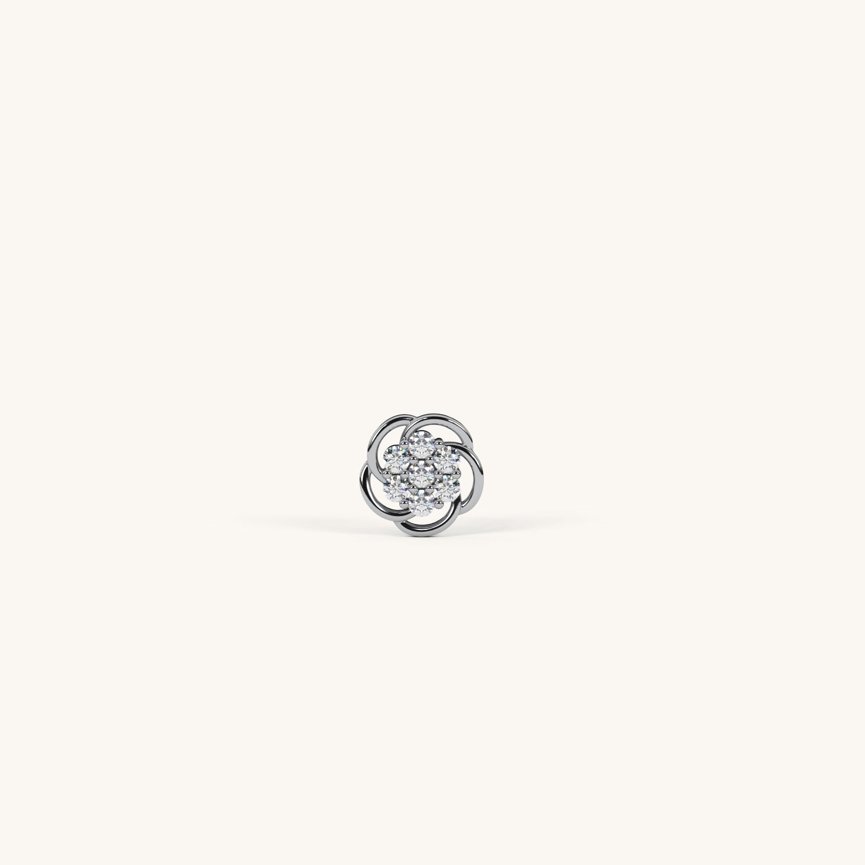Silver earring with a central gemstone on a white background