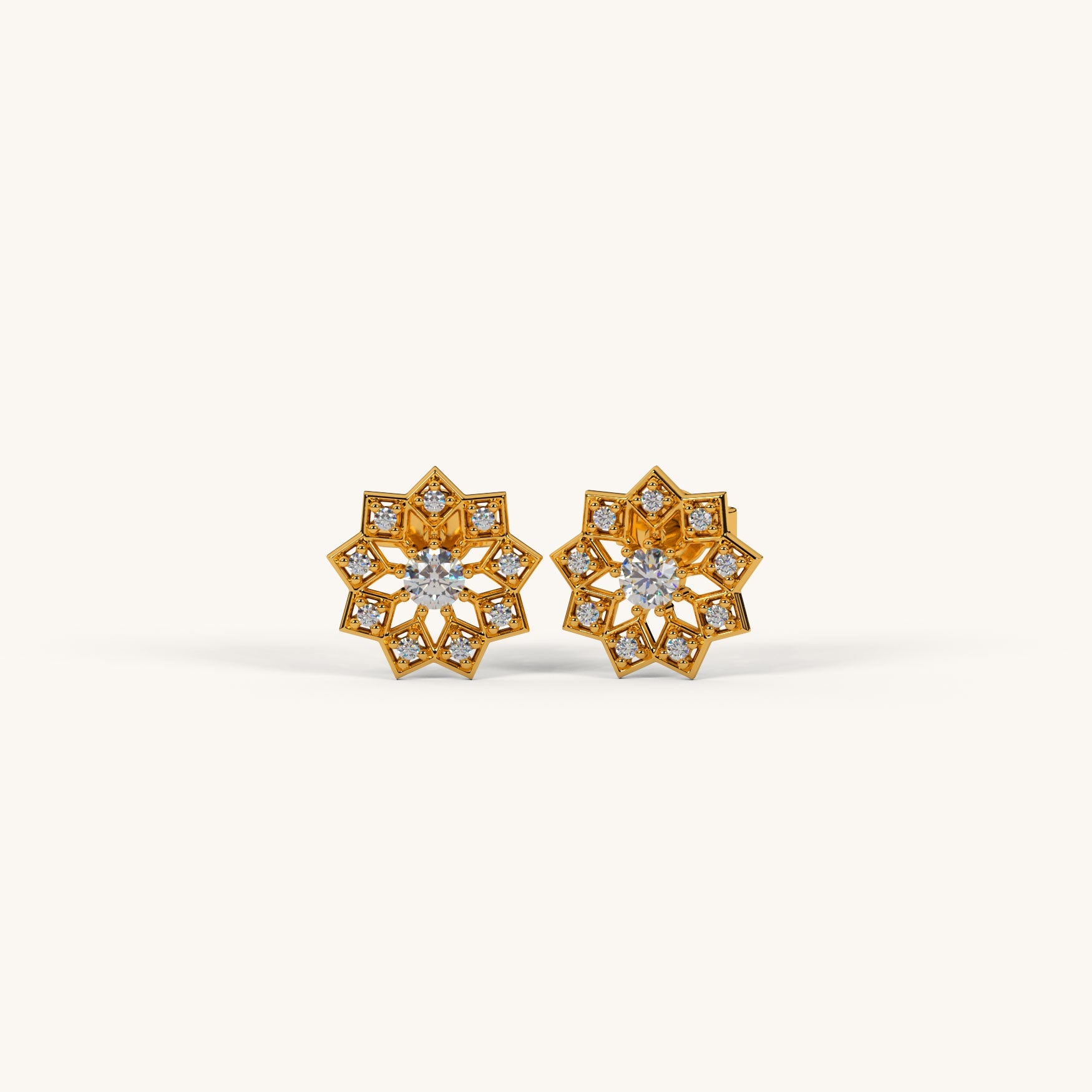 Pair of gold earrings with diamond accents on a white background