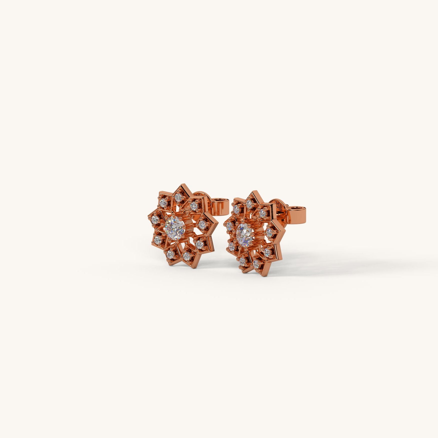 Rose gold earrings with diamond accents on a white background