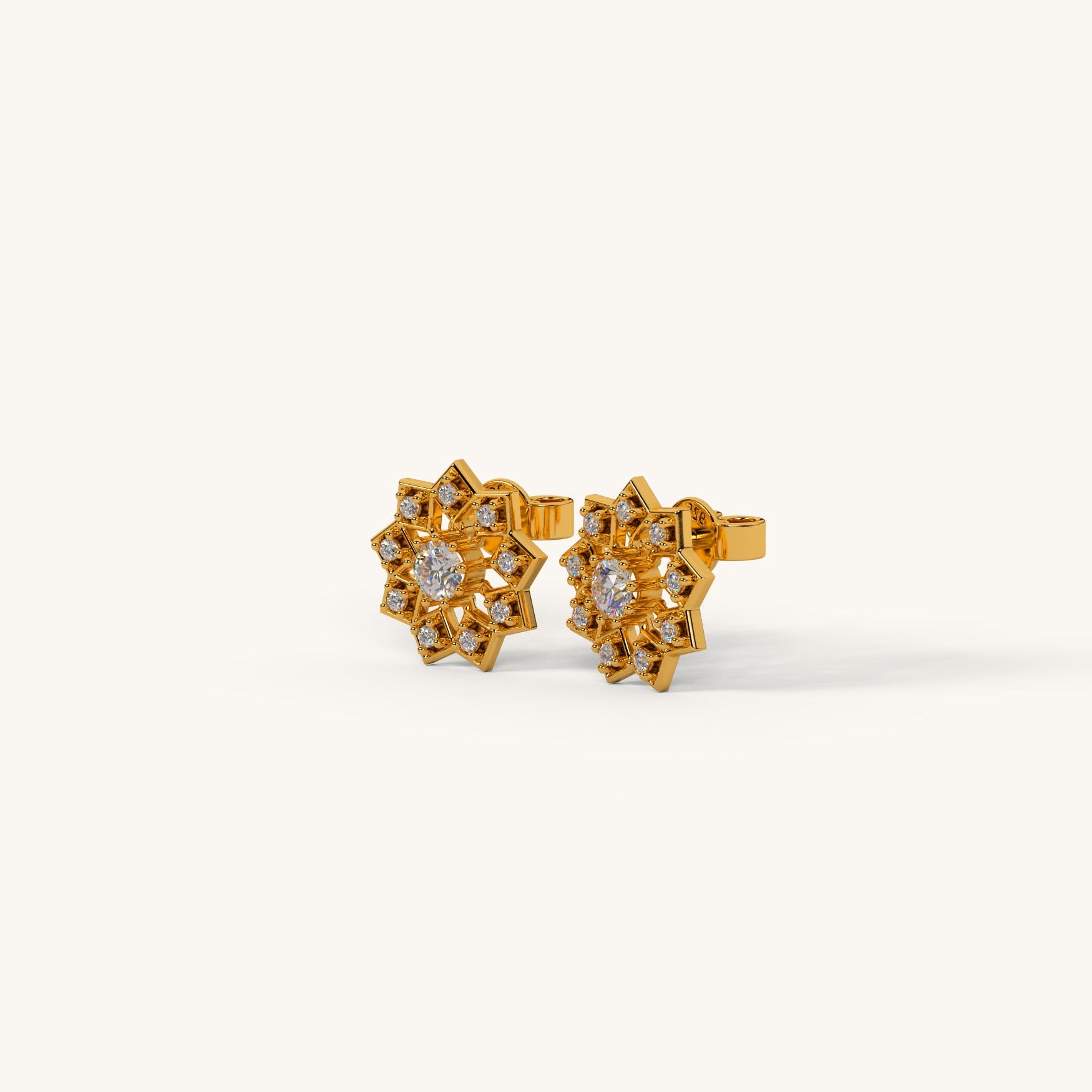 Gold earrings with floral design on a white background