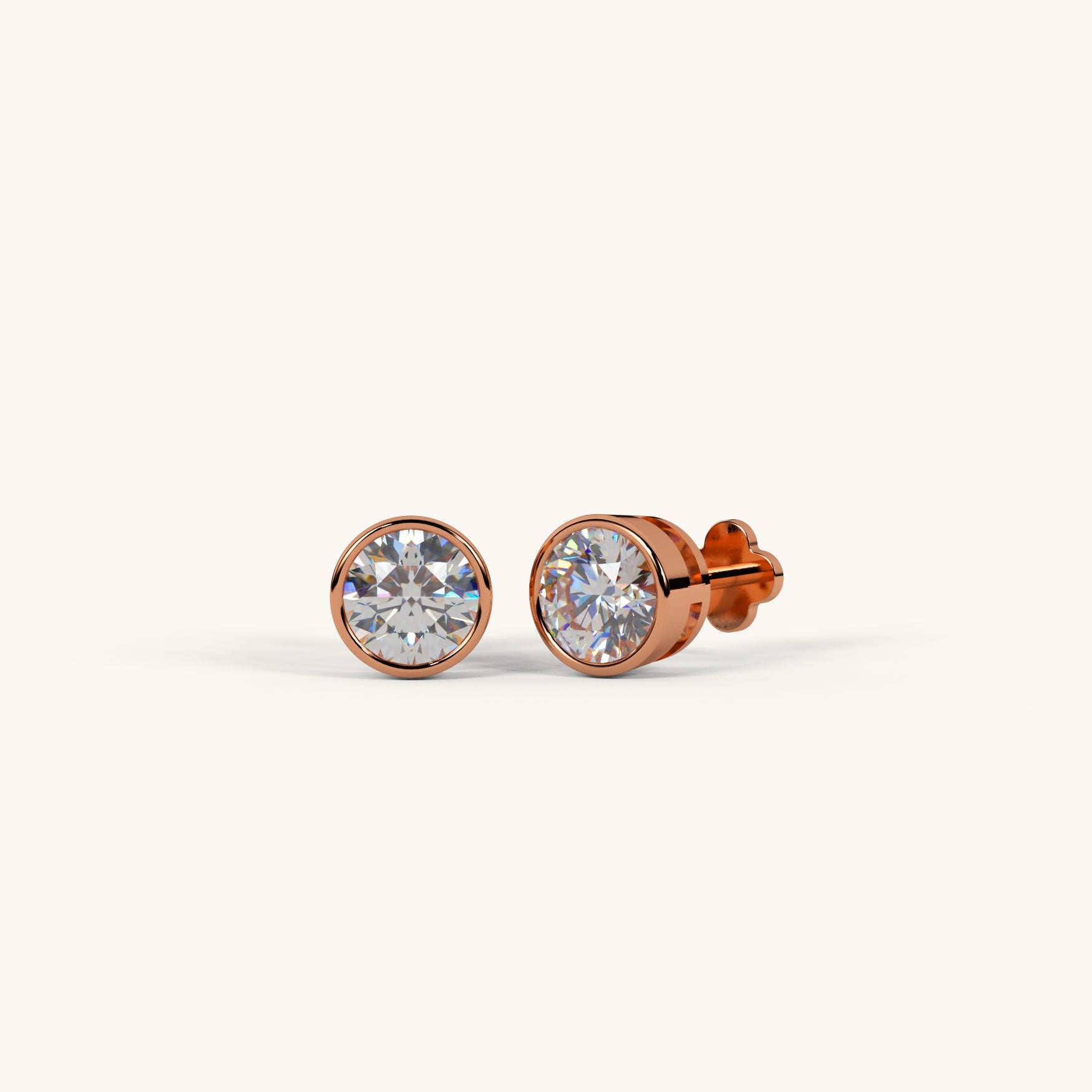 Rose gold stud earrings with clear gemstones on a white background