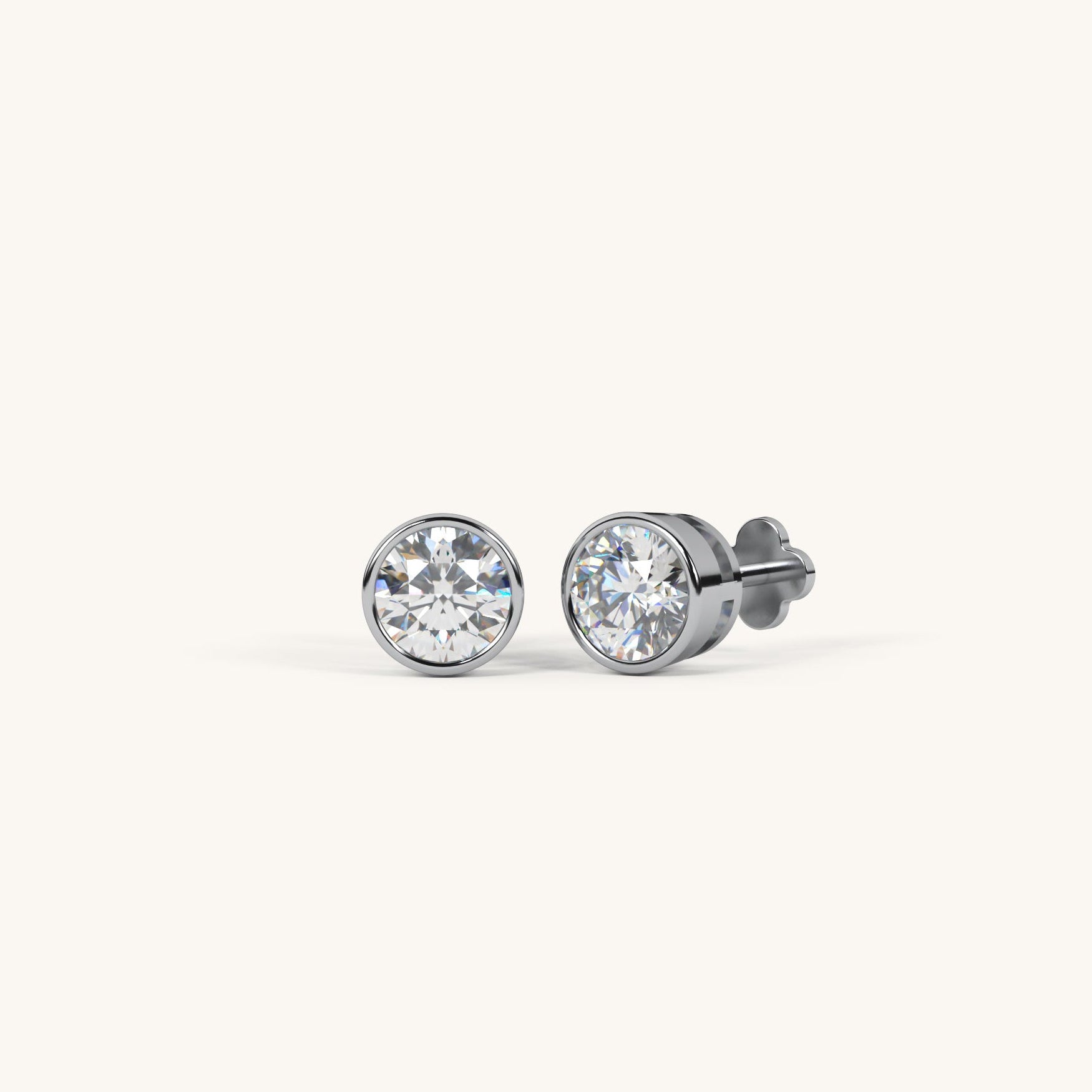 Pair of diamond stud earrings on a white background