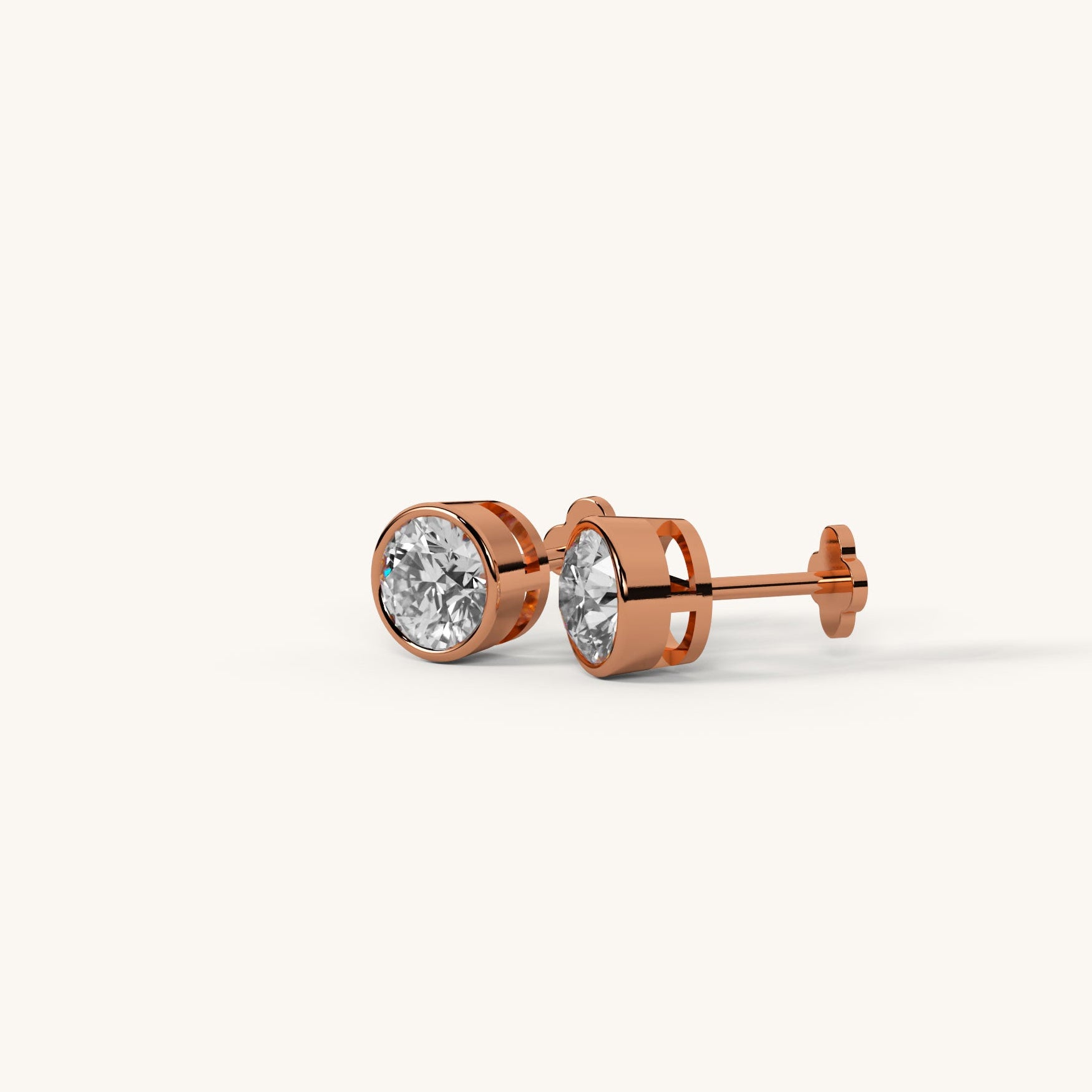 Rose gold earrings with clear gemstones on a white background